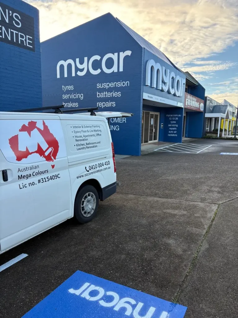 Commercial automotive service centre exterior with Australian Mega Colours van on site during commercial painting works