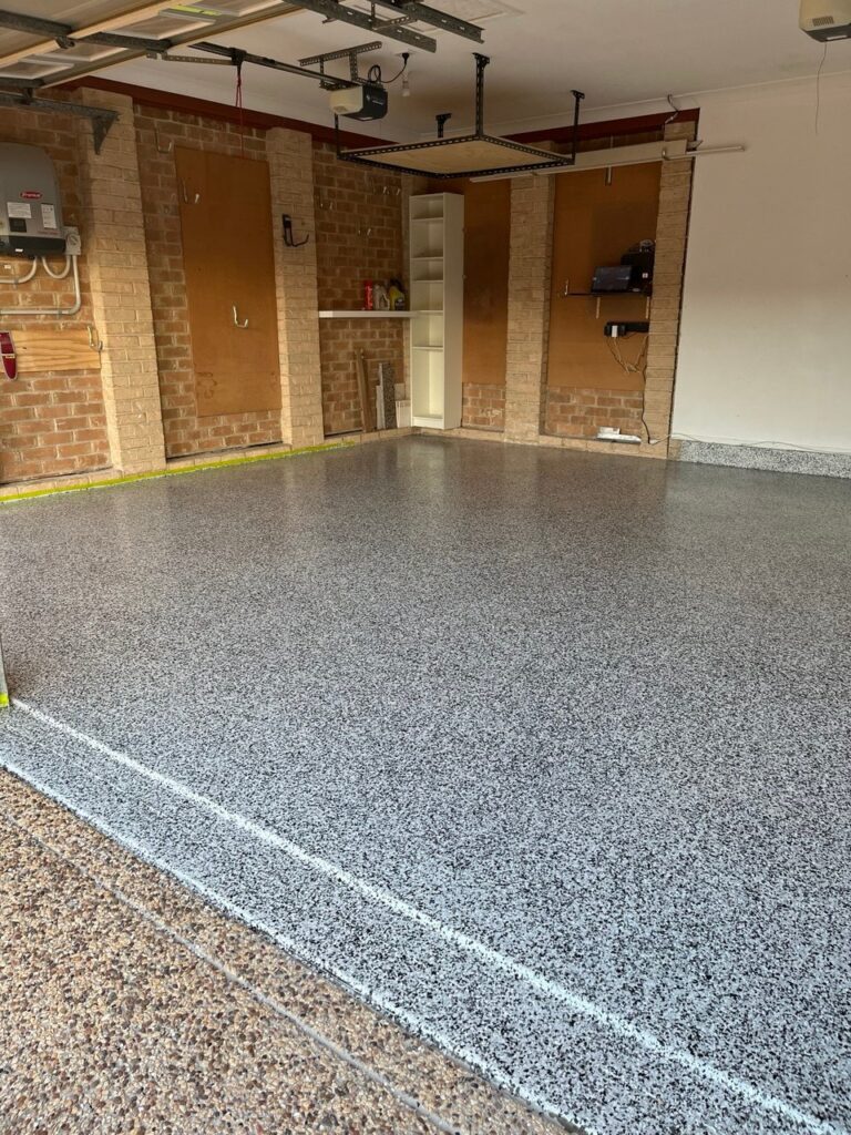 Residential garage epoxy flooring with decorative flake finish and seamless surface