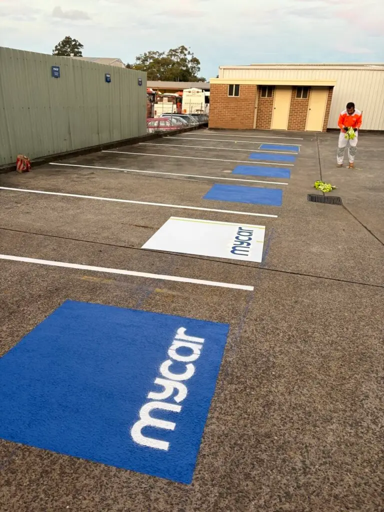 Commercial renovation showing branded parking bays and line marking works in an external car park